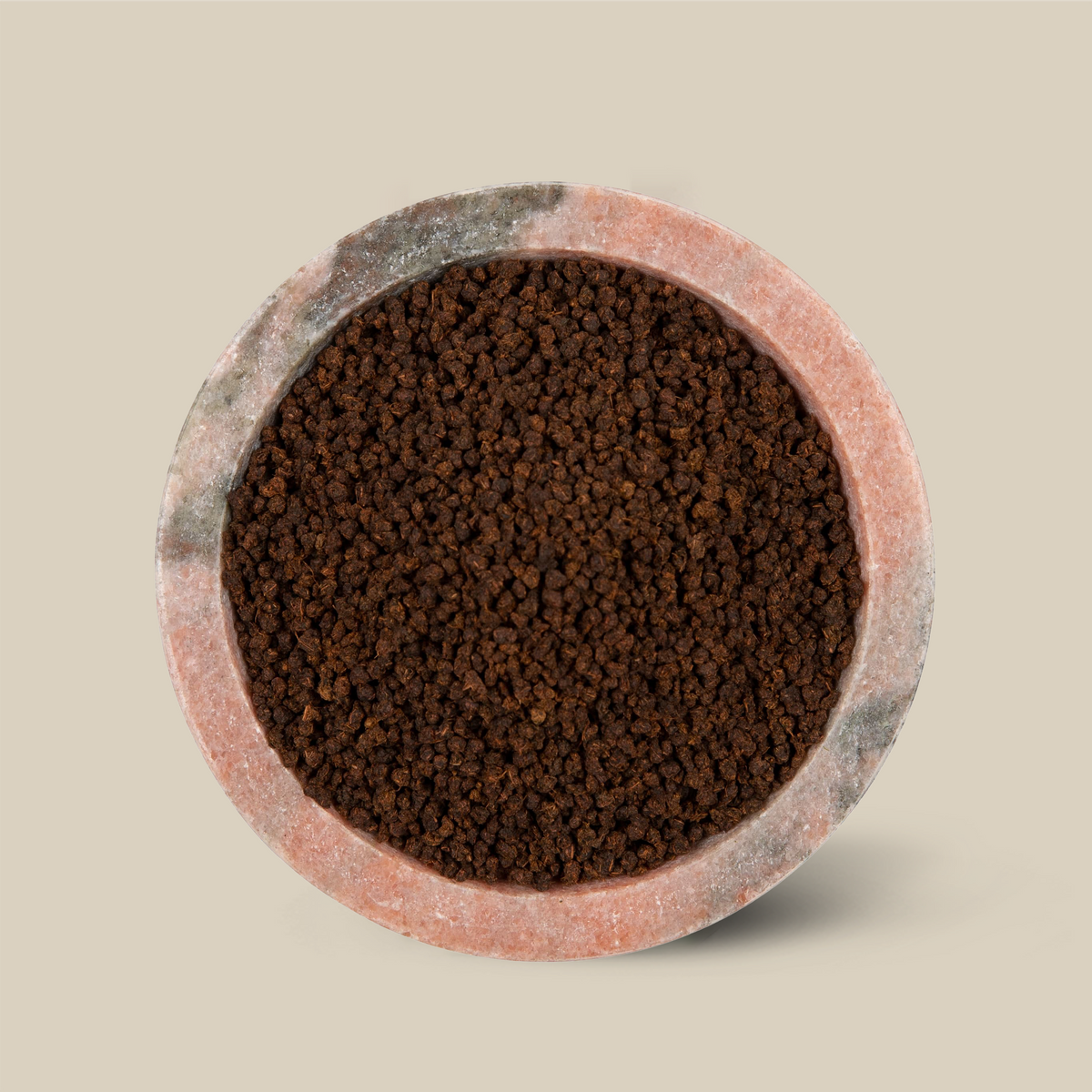 Assam CTC from Jalinga Estate, small dark granular black tea in a stone bowl