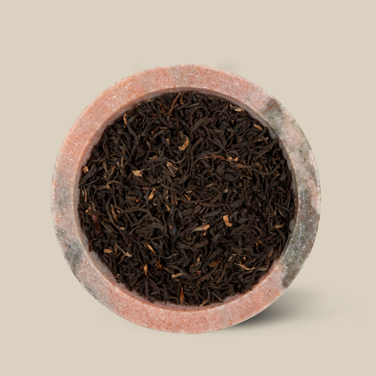 Assam Dejoo long leaf black tea in a stone bowl