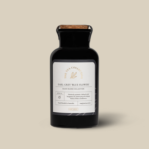 A black bottle of Earl Grey tea with a label that reads 'Earl Grey Blue Flower'.