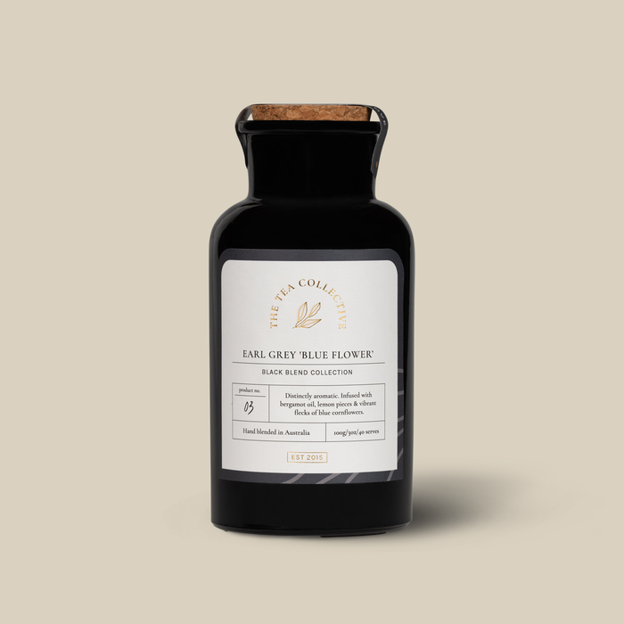 A black bottle of Earl Grey tea with a label that reads 'Earl Grey Blue Flower'. 